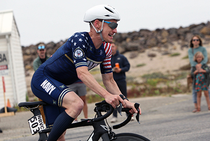 Navy Lt. Cmdr. Kyle Hooker of the Pentagon rides to his seventh gold medal during the 2024 Armed Forces Triathlon Championships was held at Naval Base Ventura County, Calif., June 26-30. Service members from Army, Marine Corps, Navy (with Coast Guard) and Air Force (with Space Force) battled alongside the Canadian forces for gold. (U.S. Army photo by Master Sgt. Sharilyn Wells/USACAPOC(A) PAO)